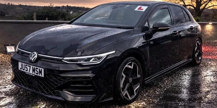 Close-up of the black Volkswagen Golf R Line tuition car with an L plate